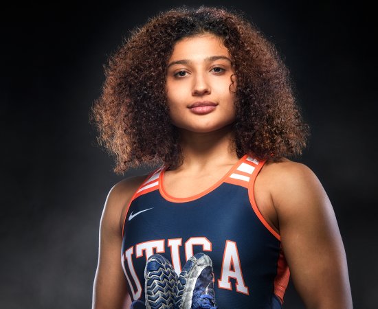 Jazmene Molina in a Utica Pioneers jersey, stands against a black background.