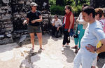 Carolynne Whitefeather discusses the mosaics on the floor of the baptistery with a group of Albanian high school students.