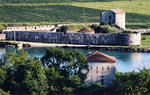 A view from the Acropolis, looking over a Venetian tower and triangular fortress built along the Vivari Channel around 1500.