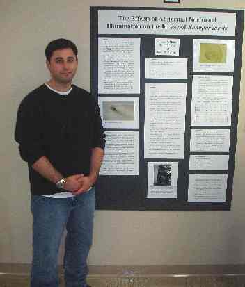 A student presents research in biology.