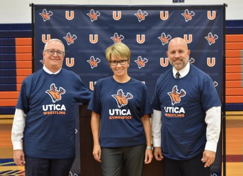 From left to right - Provost Todd Pfannestiel, President Laura Casamento, and Athletic Director Dave Fontaine all wearing Utica Pioneers-branded t-shirts announcing new Varsity sports at Utica.