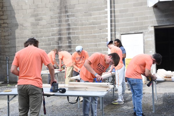Utica students volunteer building beds for children at the non-profit Sleep in Heavenly Peace