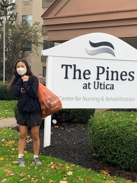 Young scholars student poses as she collects donated sneakers for our “Got Sneakers” Community Service Project