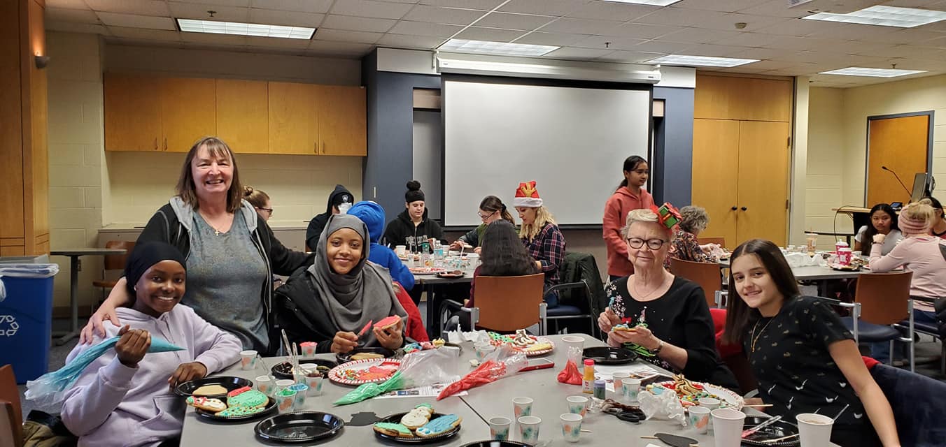 Young Scholar and their Mentors Decorating Cookies at Utica College
