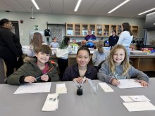 Elementary students in a lab during a field trip to Utica University.