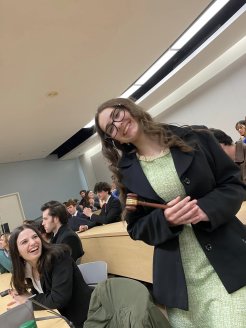 Member of the Utica Mock Trial tema holds a gavel at the 2023 regionals.
