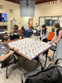 aculty, and Staff cut fabric to make Tie Blankets for domestic violence victims.