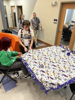 aculty, and Staff cut fabric to make Tie Blankets for domestic violence victims.