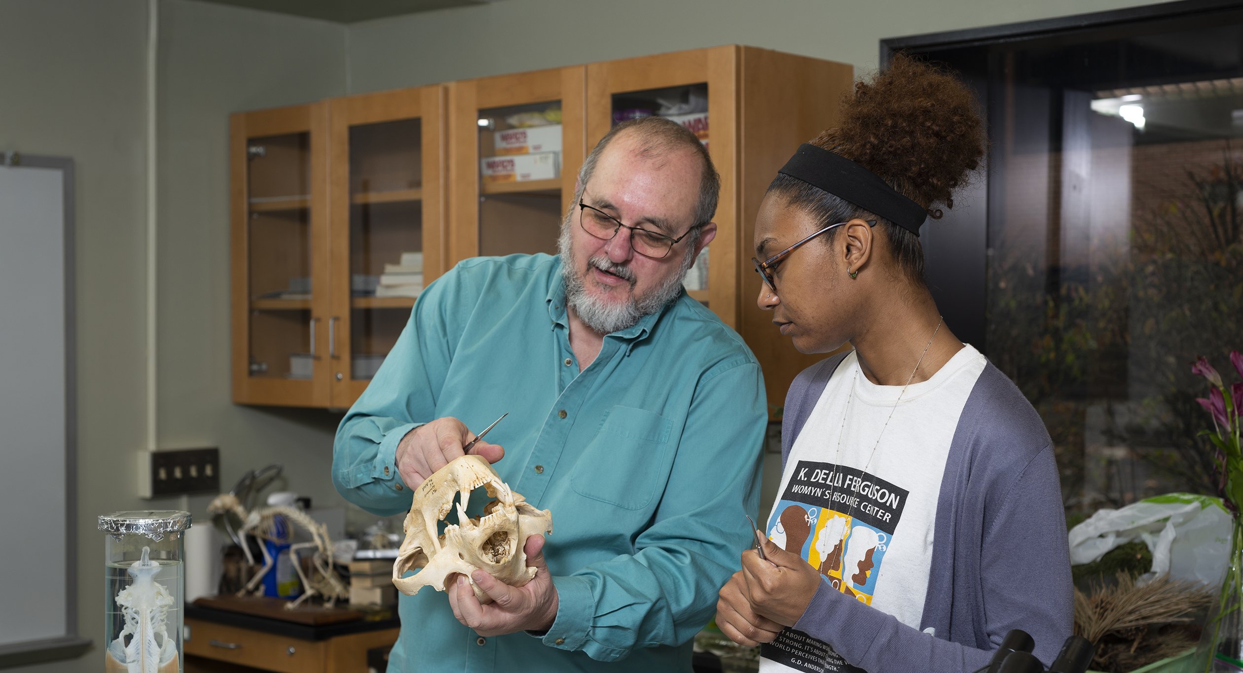 Dr. Buchanan and student observe a bear skull