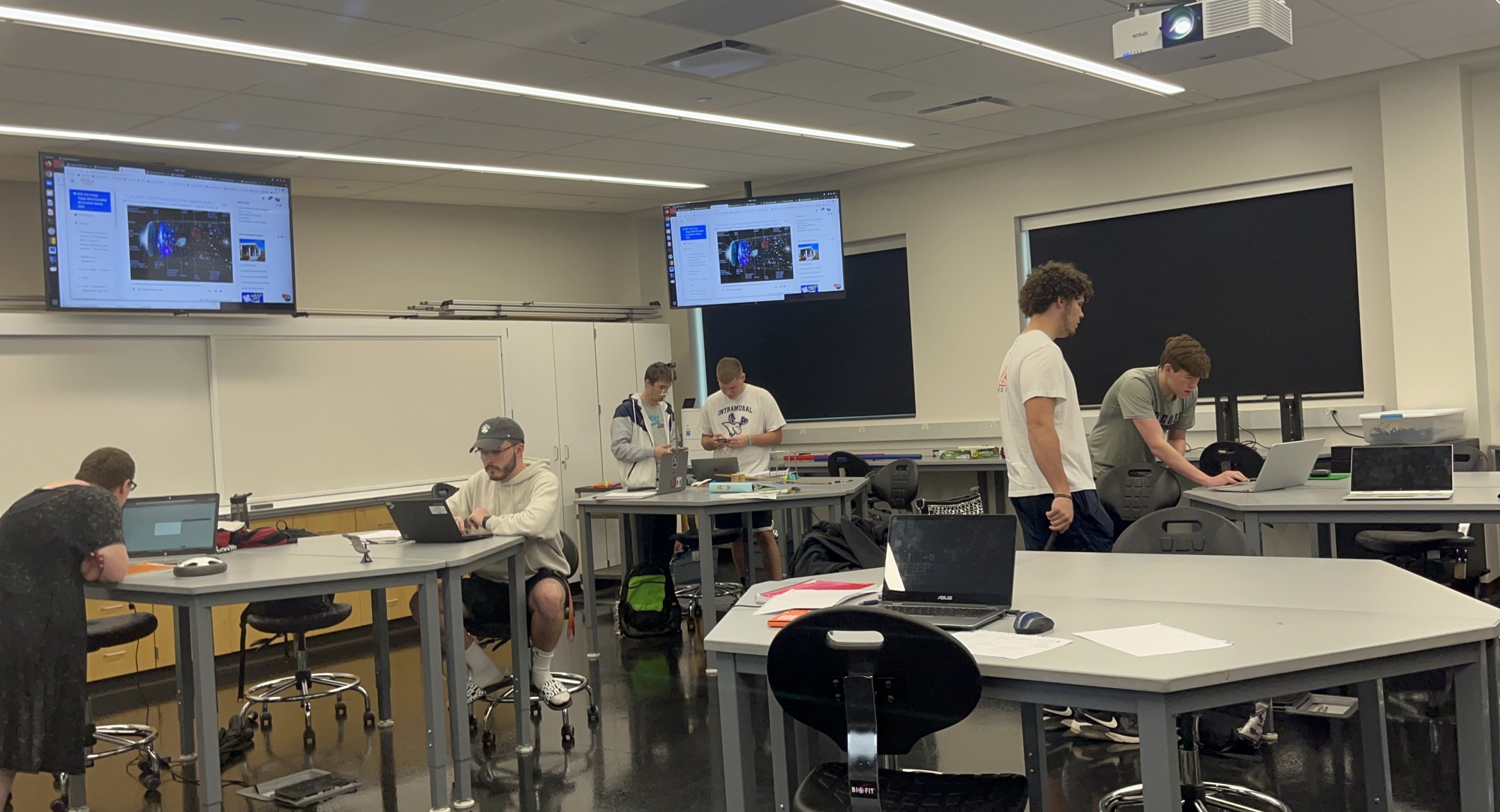 Physics Students work in a classroom.