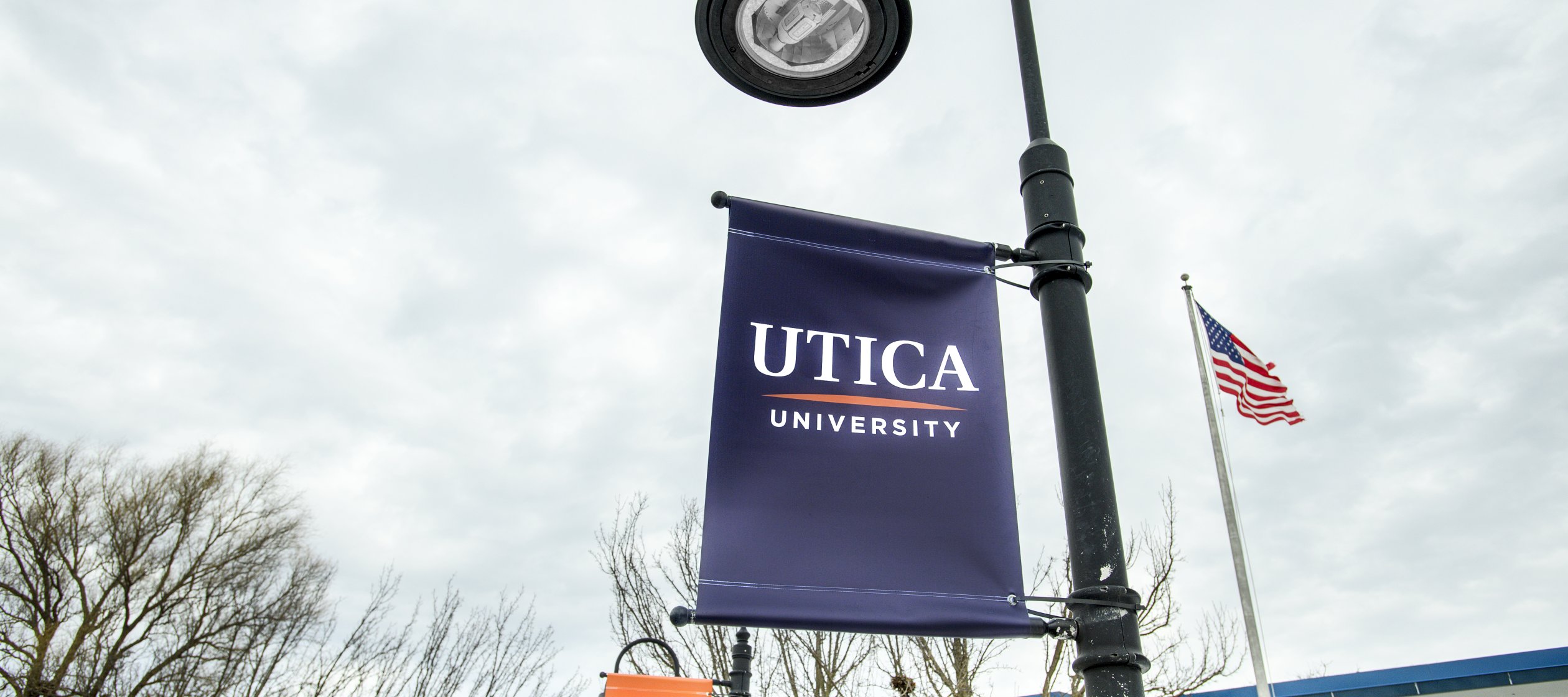 Utica banner on campus