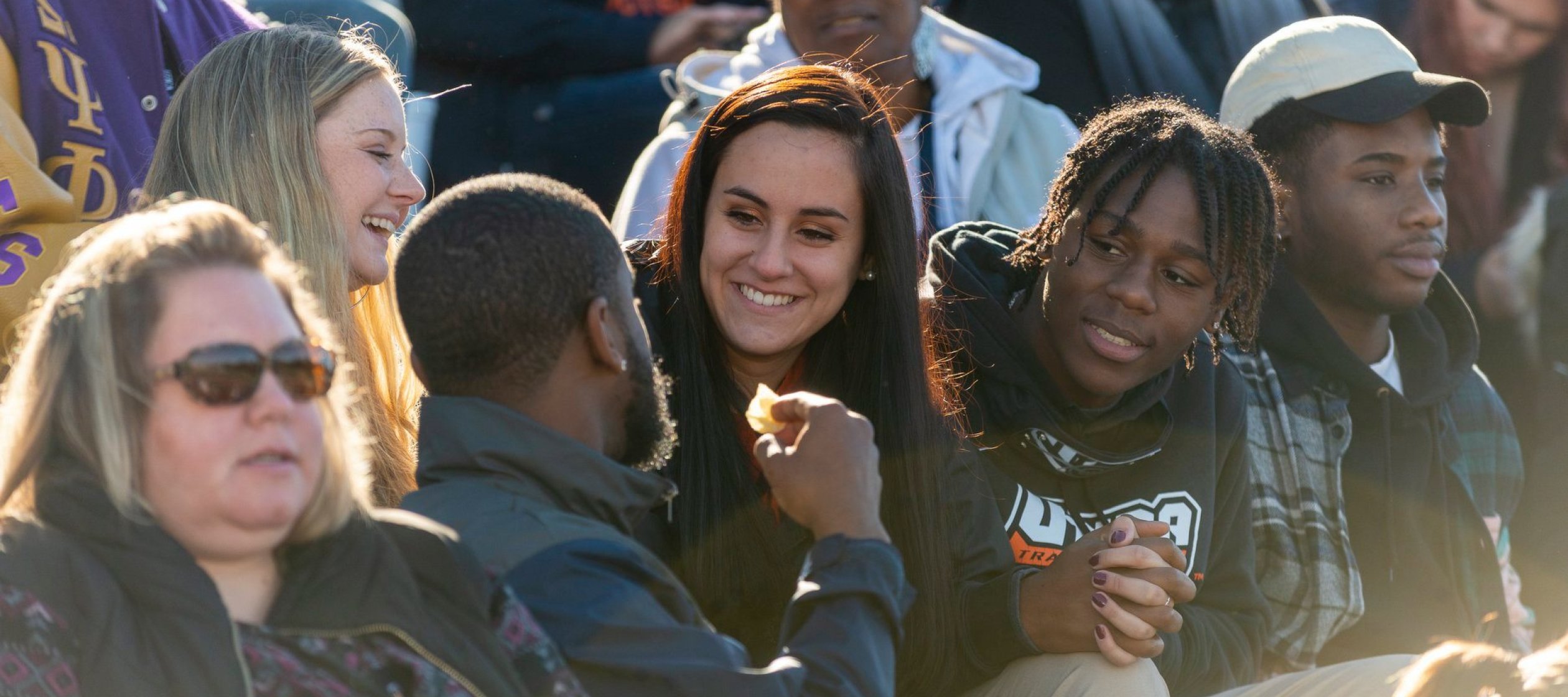 Homecoming crowd sitting in bleachers.