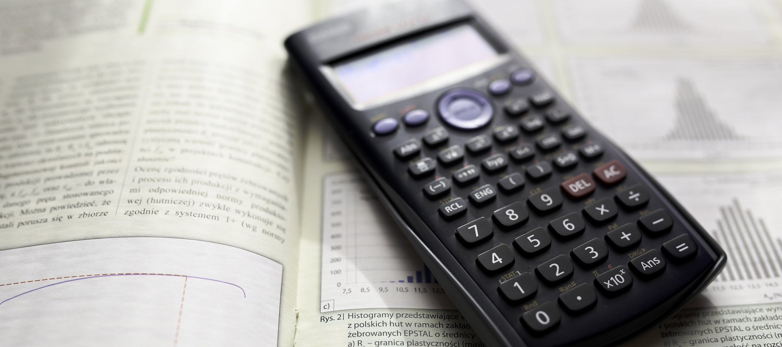 A calculator sitting on top of a math book