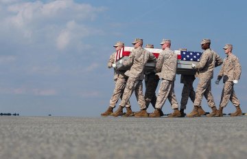 Corey Carnes 19 and team carry fallen soldier