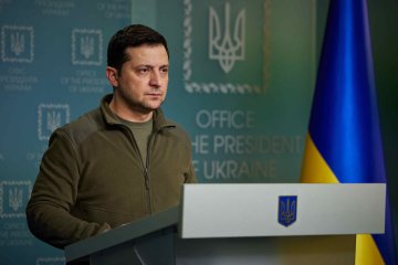 Ukrainian President Volodymyr Zelenskyy stands at a podium