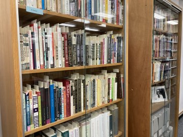 Two large bookshelves filled with items in the Sylvia Plath Colletion in the Gannett Library.