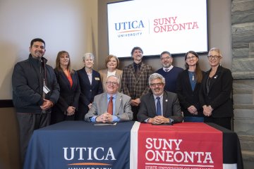 Members of Utica University and SUNY Oneonta join their respective institutional presidents for the signing of an Articulation Agreement.