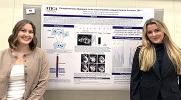 Biology students presenting at a conference