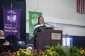 Jennifer Waters at the podium addressing the crowd at Convocation 2026.