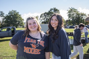 Hannah Stroup '27 wears a "Fear the Moose" shirt, standing next to a friend at Homecoming 2026