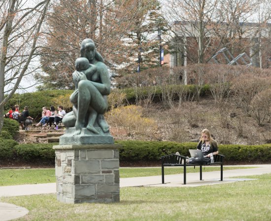 Campus Scenic Spring - Students work near statue