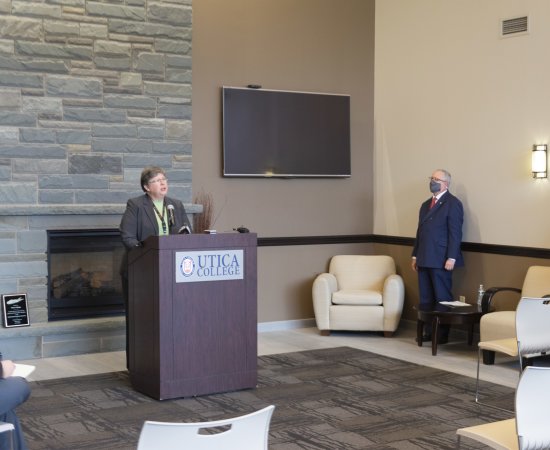 Patrice Hallock speaks at podium at gift announcement for Integrative Health Institute.