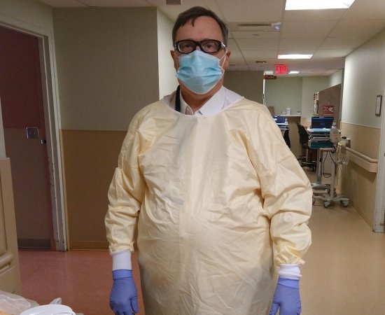 Paul Lehmann, in mask and gloves, stands in hospital.