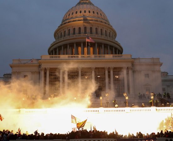 Smoke rises amid mobs assaulting the captiol on January 6, 2021.