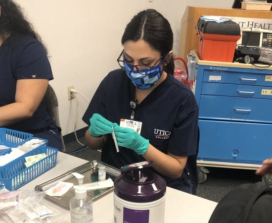 Nursing Student at UC's St. Petersburg site helps administer COVID-19 vaccines.