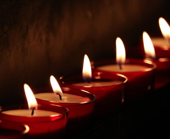 Eight lit tea candles
