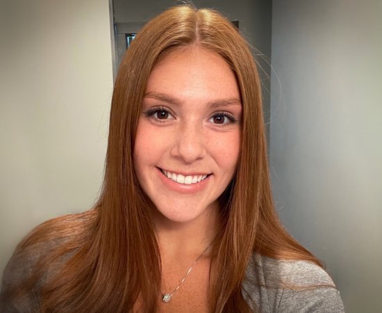 Headshot of Maryanne Lazore '21, smiling at camera in hallway.