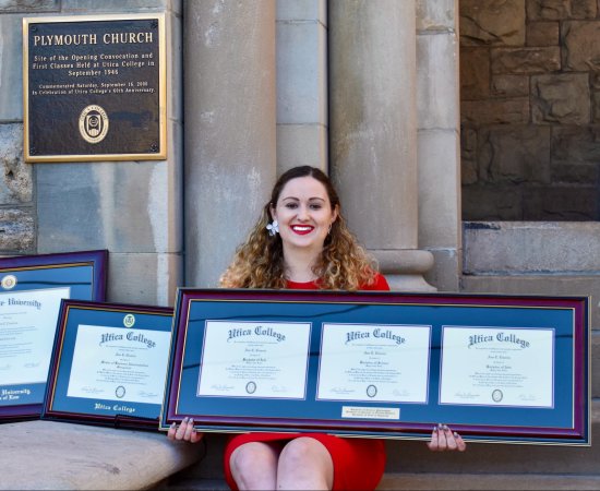 Ann Ciancia sits outside Plymouth Church with her multiple degrees.
