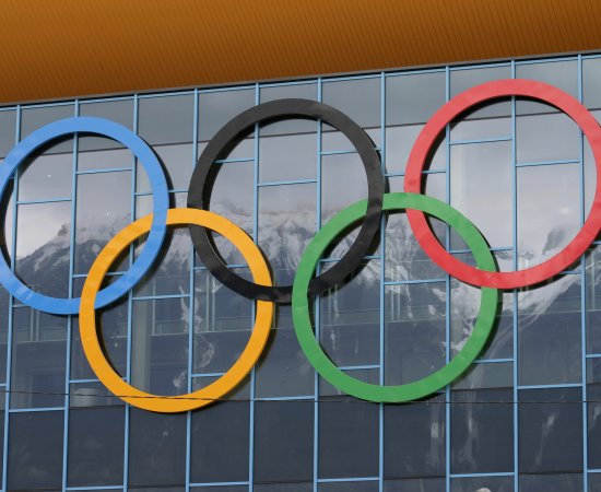 Olympic Rings on side of glass windows.
