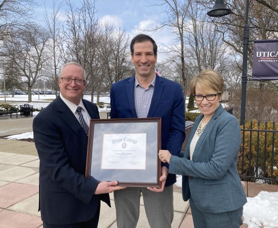 Professor Christopher Riddle receives the prestigious Clark Award, presented by Provost Todd Pfannestiel and President Laura Casamento
