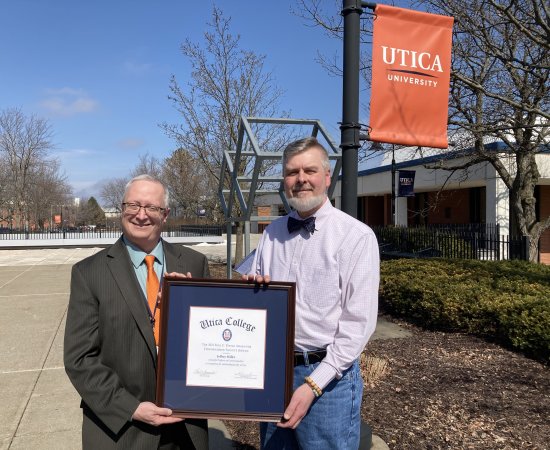 Provost Todd Pfannestiel presents the Paul Young Award to Professor Jeffrey Miller.