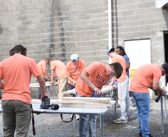 Utica students volunteer building beds for children at the non-profit Sleep in Heavenly Peace
