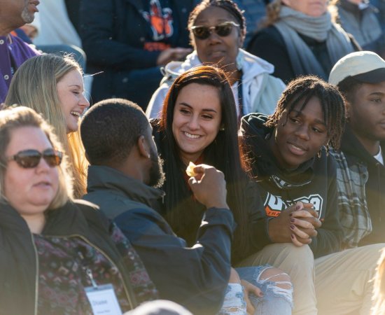Homecoming crowd sitting in bleachers.