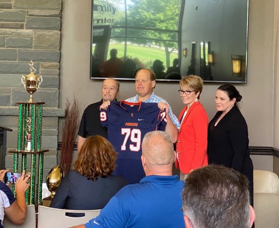 Floyd Fire Chief John Stark receives a jersey as an honorary Pioneer Captain.