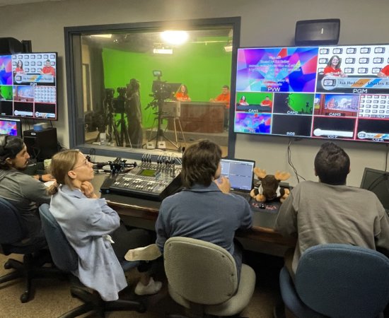Students in control room producing a TV broadcast program.