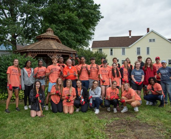 Group of students with President Pfannestiel at a Pioneer Pitch In Volunteer Site.