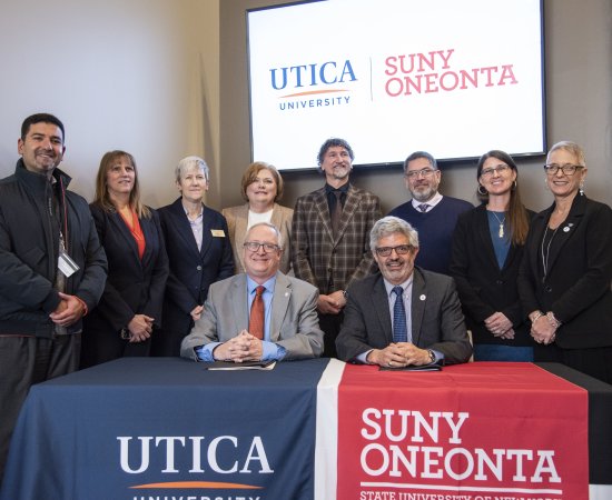 Members of Utica University and SUNY Oneonta join their respective institutional presidents for the signing of an Articulation Agreement.