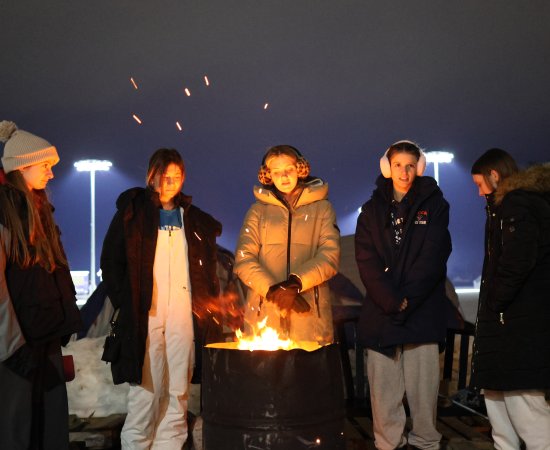 Members of the Chi Beta Sigma sorority warm near a fire as they brave the cold for the Deep Freeze 2025 fundraiser.