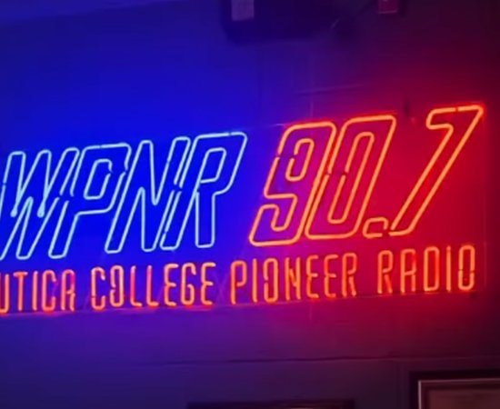 Blue and Orange Neon sign reading WPNR 90.7 Utica College Pioneer Radio