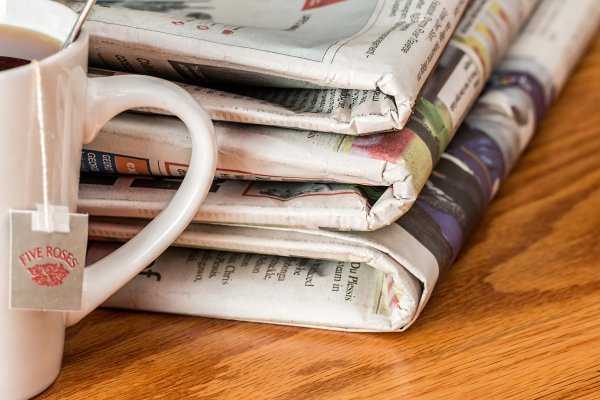 Newspaper Stack with cup of tea Generic