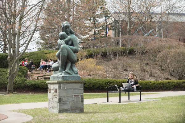 Campus Scenic Spring - Students work near statue