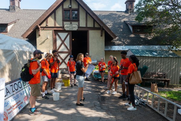 Executive Director of the Utica Zoo Andria De Lisle-Heath guides Utica College students through work at the Utica Zoo as part of Pioneer Pitch-In.