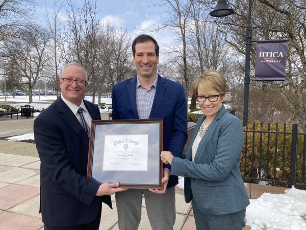 Professor Christopher Riddle receives the prestigious Clark Award, presented by Provost Todd Pfannestiel and President Laura Casamento