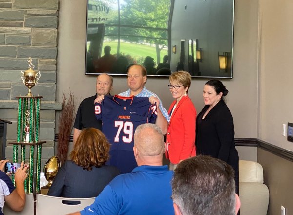 Floyd Fire Chief John Stark receives a jersey as an honorary Pioneer Captain.