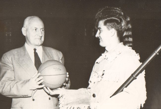 Pioneer mascot handed basketball.