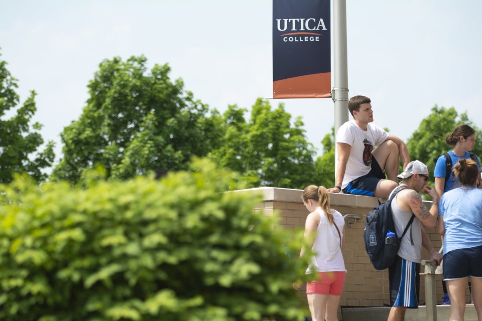 Campus Scenic - Students sit on wall